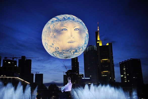 31 May 2009: Frankfurt, Germany: An acrobat hanging on a balloon above the Main river