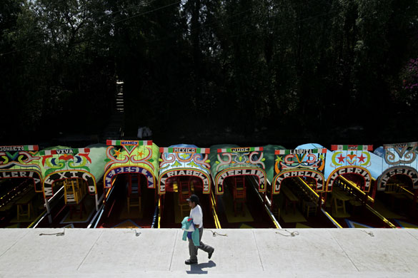 4 May 2009: Mexico City, Mexico: A man walks past tourist boats