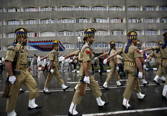 4 May 2009: Srinagar, India: Policemen march past the civil secretariat complex