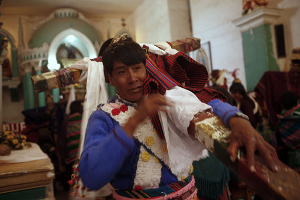 Thinku festival: A  man leaves a church carrying a cross