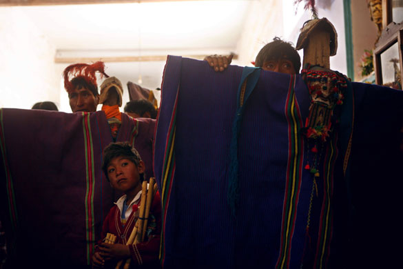 Thinku festival: People attend mass as they stand behind crosses covered with ponchos