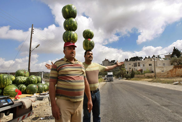 24 hours in pictures : Fruit sellers try to attract customers in Ramallah