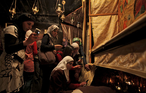 6 May 2009: Bethlehem, West Bank: Girls take pictures inside the Church of the Nativity