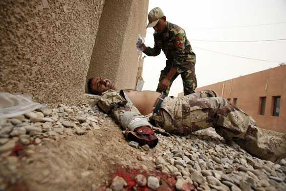 6 May 2009: Baghdad, Iraq: A soldier simulates injury during a training course