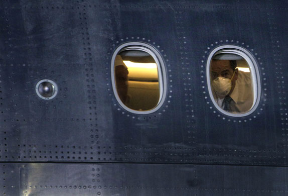 6 May 2009: Mexico City, Mexico: A man looks out of a plane as he arrives from China