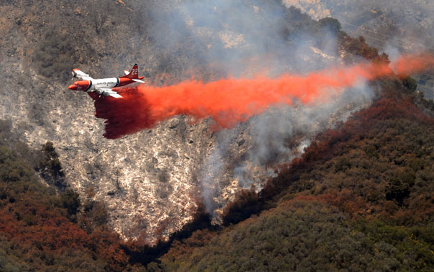 California Wildfires: A Cal Fire tanker drops it's load of fire retardant