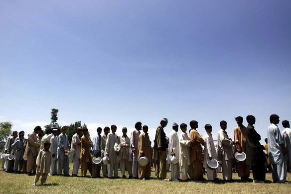 Pakistan refugees: Refugees from Swat Valley  queue for food in a camp
