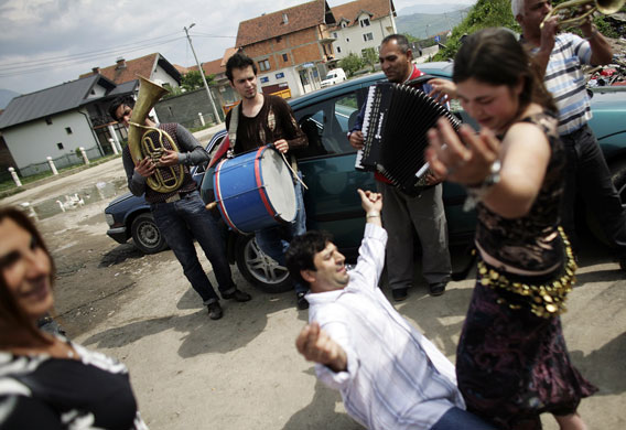 24 hours in pictures: Roma people dance as musicians play on St. George's Day or Djurdjevdan 