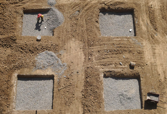 24 hours in pictures: A migrant worker works at a construction site in Changzhi,China 