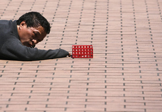 24 hours in pictures: a man begs for money in taipei