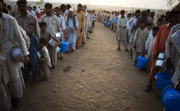 IDP camps Pakistan: Men and boys line up for their daily ration