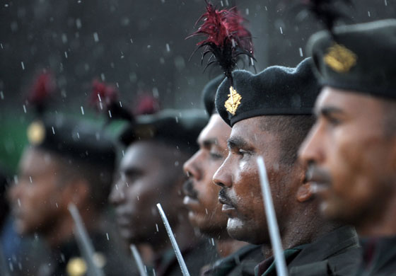 1 June 2009: Colombo, Sri Lanka: Troops endure a rainshower