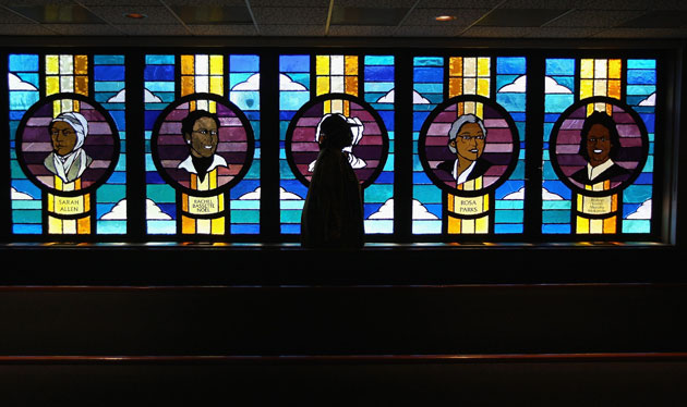 1 June 2009: Denver, US: A woman walks past stained glass windows