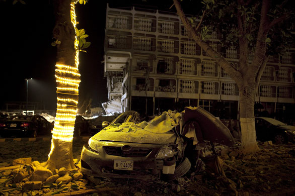 Peshawar bombing: A car is badly damaged after a bomb blast at the Pearl Continental Hotel