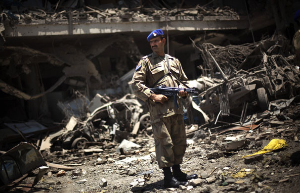 Peshawar bombing: A Pakistani army soldier inspects the debris of Pearl Continental hotel 