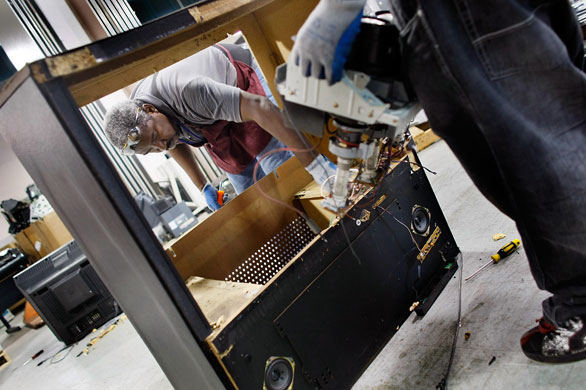 24 hours: Florida, US: David Ferguson and William Hall recycle an old television set