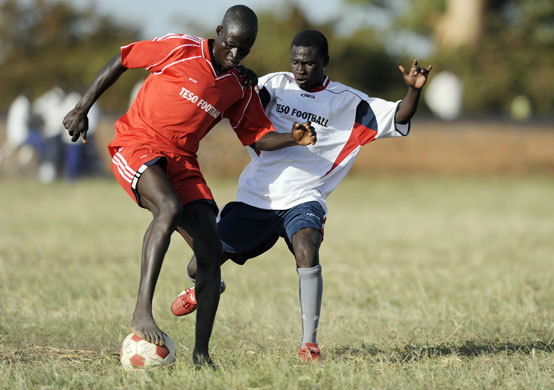 Katine: The Eagles FC Ananius Ochen (L) is tackled by Katine Actors Moses Okotcha