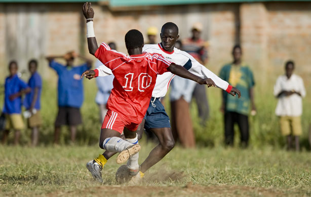 Katine: Katine Actors Moses Eladu (R) is met by Eagles FC Max Eguba