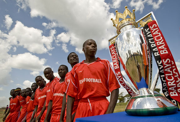 Katine: The Olwelai Black Mambas pose with the Barclays Premier League trophy