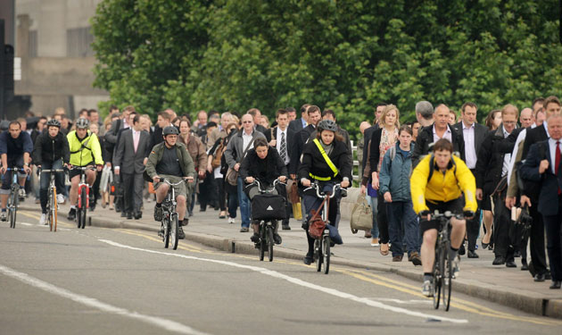 Tube strike: Waterloo Bridge: Commuters walk and cycle across the bridge