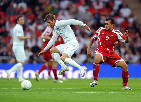 england andorra: David Beckham evades a clumsy challenge from Andorra's Fernando Silva 