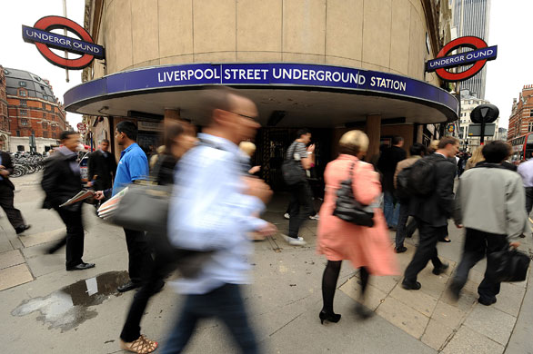 Tube strike: Commuters walk past a closed underground station