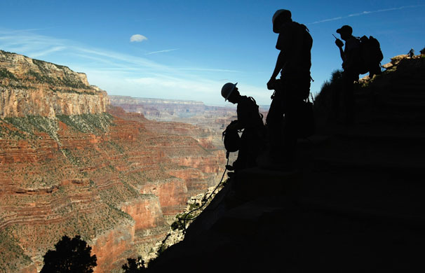 24 hours: Arizona, US: Workers carry heavy rocks used in repairing a trail