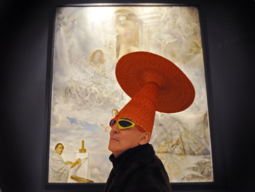 24 hours: Melbourne, Australia: Tim McKew inspects a painting by Salvador Dali