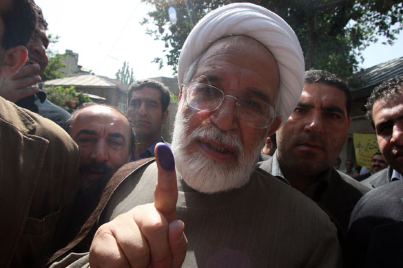 Iranian elections: Presidential candidate Mehdi Karroubi shows his ink-stained finger