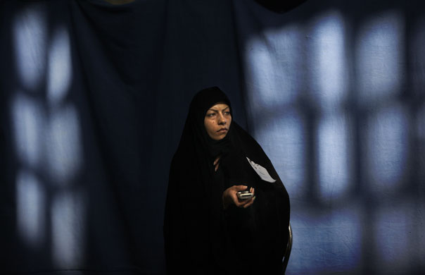 Iranian elections: An electoral official observes proceedings in the polling station