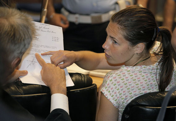 Meredith Kercher trial: Amanda Knox speaks with her lawyer prior to a session of the trial