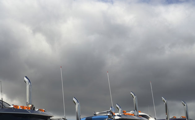 megatrucks: Exhaust pipes of semi-trucks against clouds
