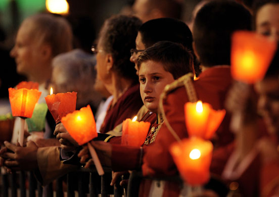 12 June 2009: Rome, Italy: Worshipers hold candles during a Corpus Domini procession