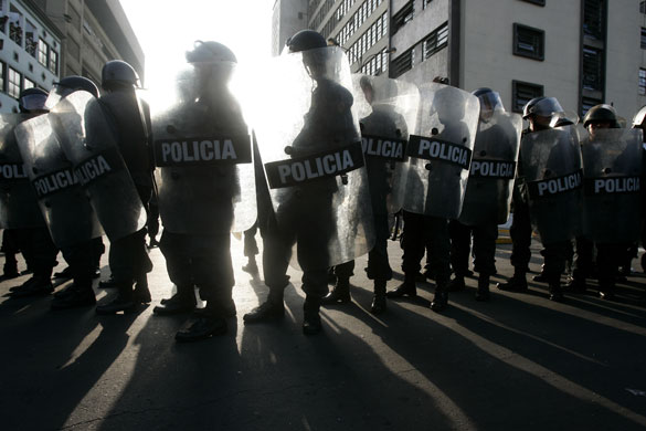 12 June 2009: Lima, Peru: Riot police officers take position during a protest