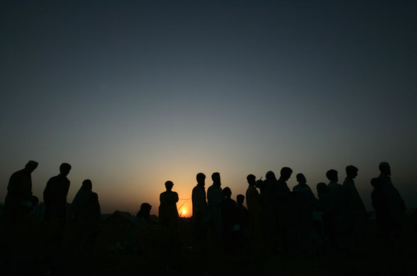 12 June 2009: Swabi, Pakistan: Internally displaced people stand in a queue