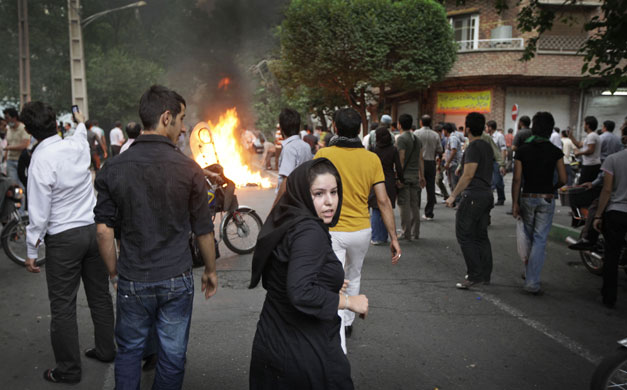 Riots in Tehran: An Iranian girl amongst protesters on the streets of Tehran