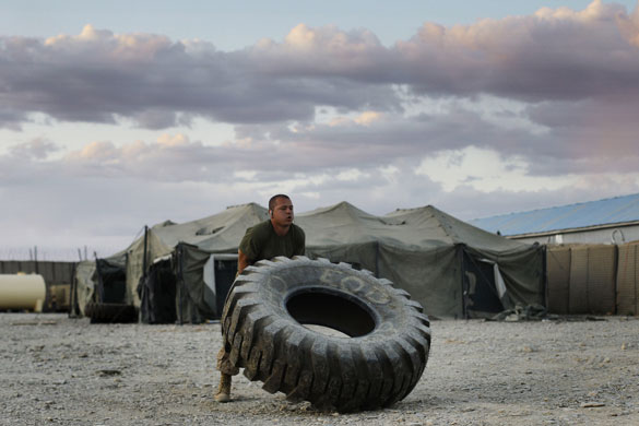 24 hours: Afghanistan: A marine works out by flipping a heavy truck tire