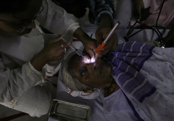 15 June 2009: Siliguri, India: A woman receives treatment at a free eye-care camp