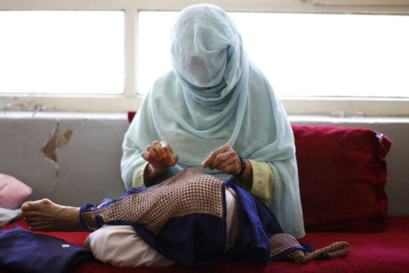 15 June 2009: Kandahar, Afghanistan: A woman works on a form of embroidery called Khamak