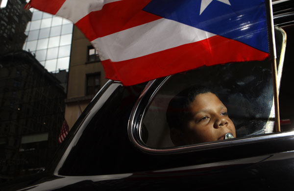 15 June 2009: New York, US: A participant rides in a car during Puerto Rican Day Parade