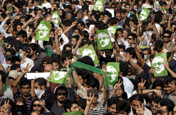 Tehran protest: Protestors wave pictures of Mousavi 