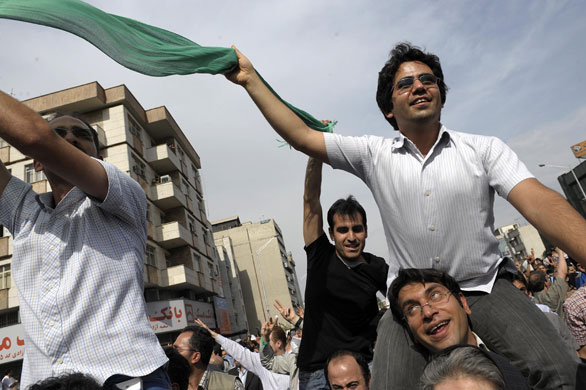 Tehran protest: Supporters of Mir Hossein Mousavi wave green flags