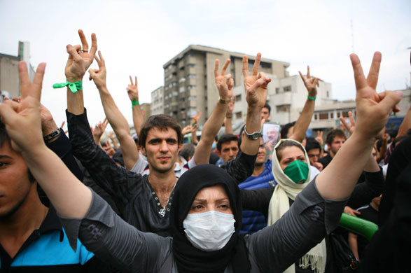 Iran protests: Supporters of Mousavi make victory signs