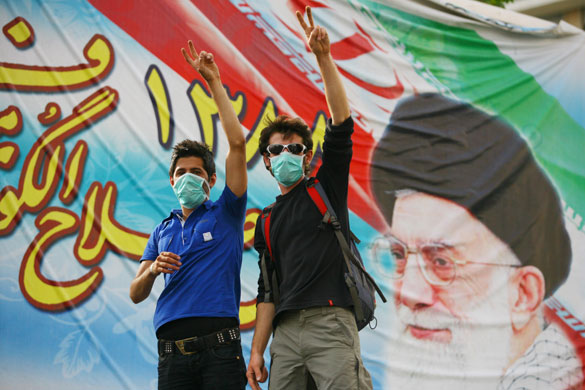 Iran protests: Protesters wear masks and wave the peace sign