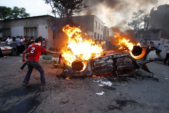 Iran protests: A car is set alight next to the pro-government militia base