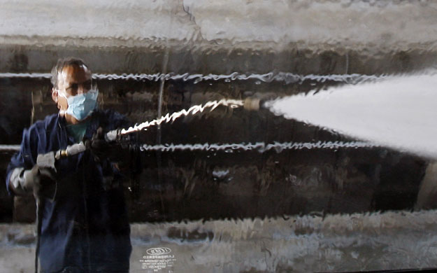 24 hours: Cairo, Egypt: A worker hoses down a train