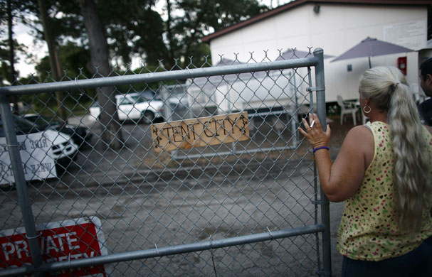24 hours: Florida, US: A resident closes the door of a tent city