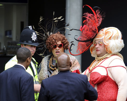 Ladies' Day at Ascot: Two men dressed as large women chat with the police before being evicted