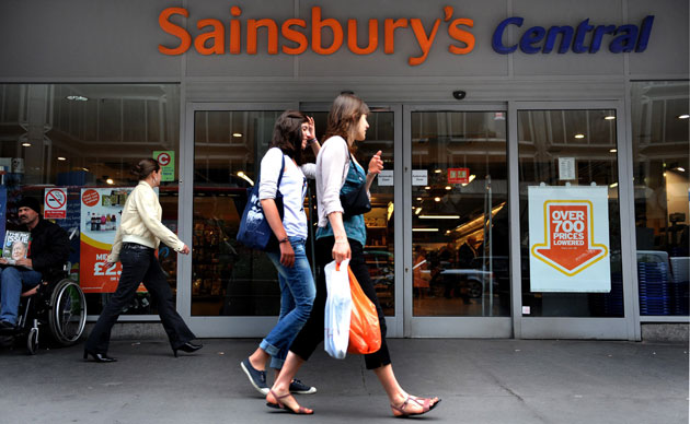 Week in Business: Pedestrians pass a Sainsbury's store in London