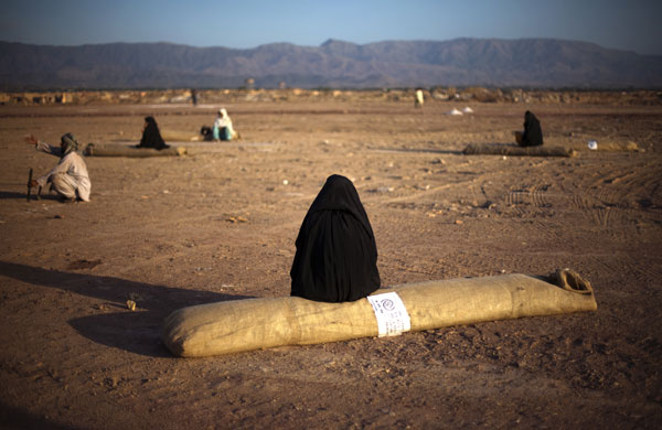24 hours in pictures: Pakistani displaced women from Swat valley sit on their unfolded tents